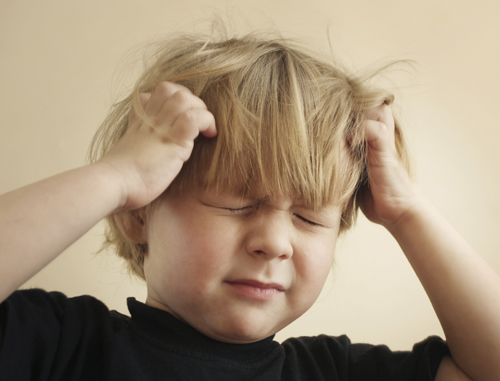 boy scratching head