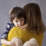 mom holding son in her arms Thumbnail