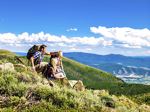 family hiking as they over across the valley
