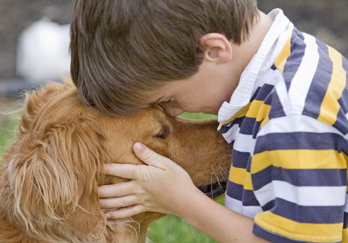 boy holding his dog