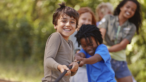 kids playing tug of war at camp