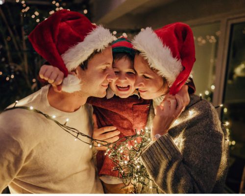 dad son and mom with santa hats and lights