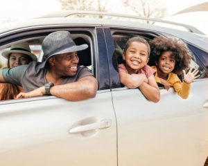 family in car for roadtrip