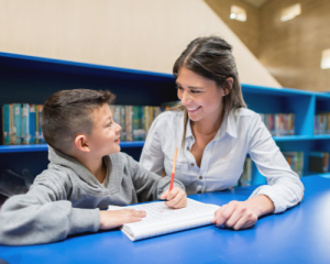 Young woman tutoring a boy student